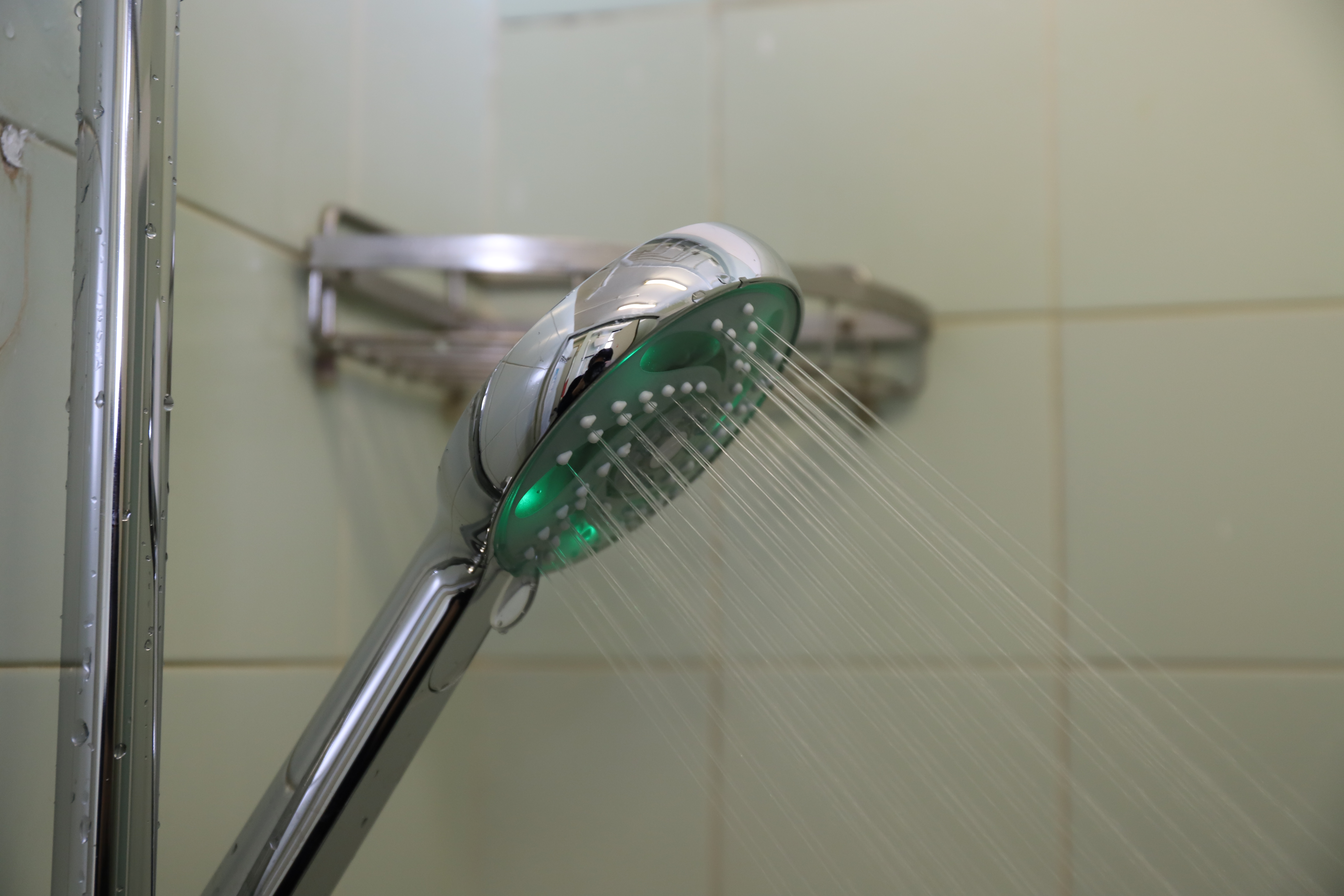 Smart showerhead with green light on.