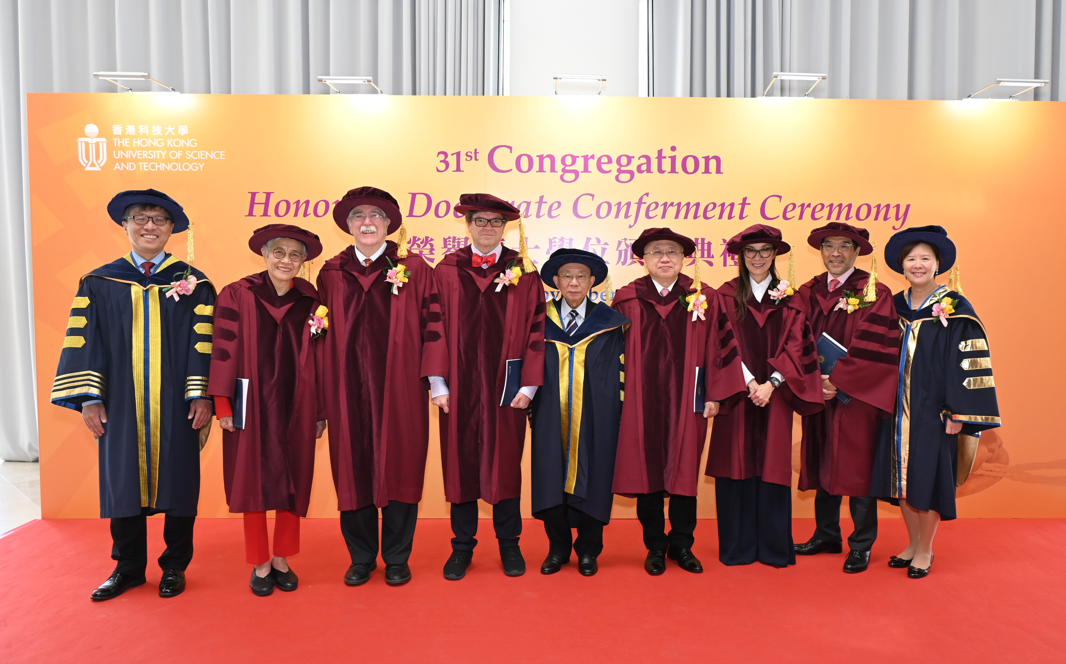 A group photo of HKUST Pro-Chancellor Dr. John CHAN Cho-Chak (middle), HKUST Council Chairman Harry SHUM (first left), HKUST President Prof. Nancy IP (first right), with the six Honorary Doctorate recipients (from left to right, in red robes) - Prof. Virginia LEE Man-Yee, Prof. Eric WIESCHAUS, Prof. Yann LECUN, Dr. Andrew LIAO Cheung-sing, Dr. Michelle YEOH Choo-Kheng and Dr. Carlson TONG.