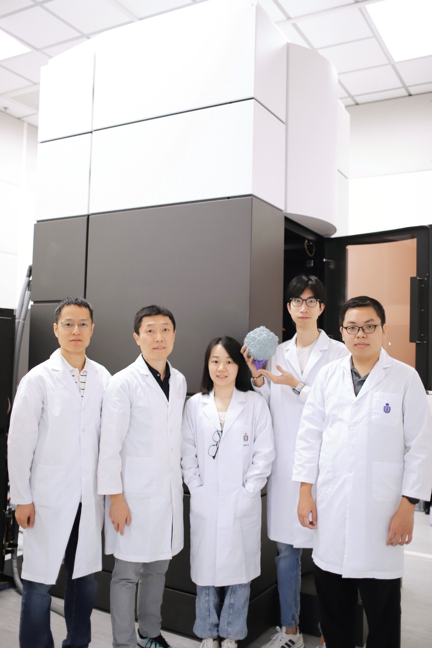Photo of the research team, featuring Prof. DANG Shangyu, Prof. ZENG Qinglu, Dr. CAI Lanlan, Mr. LIU Hang (With the 3D printed cyanophage structure in his hands), and Mr. XIAO Shiwei, from left to right.