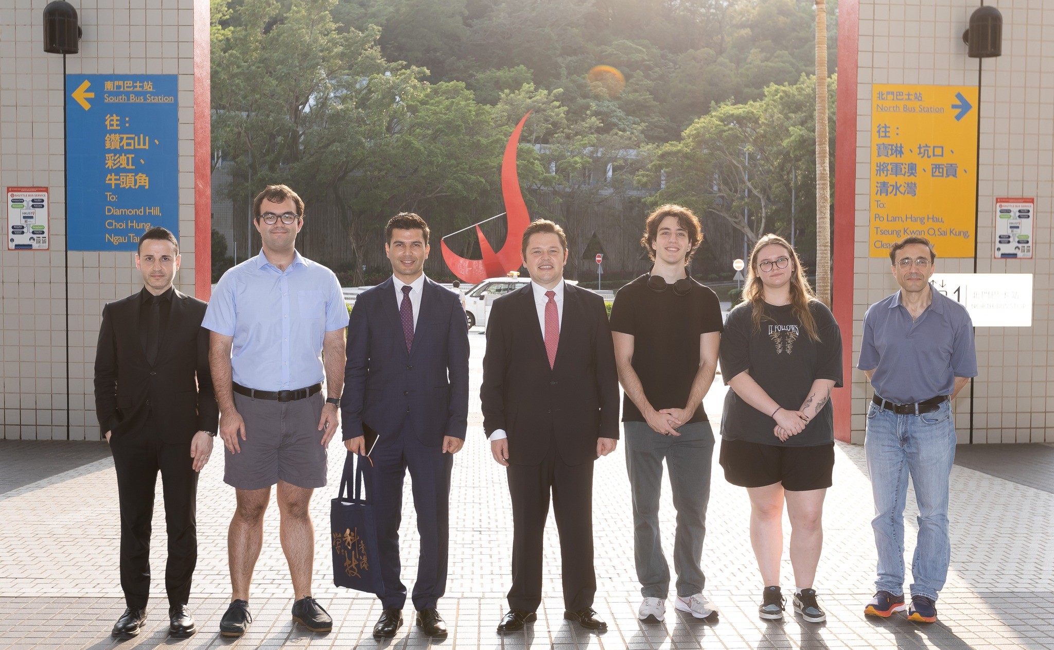 Consul General Evcin and his delegation takes a photo in front of the iconic “Red Bird” sculpture at the Piazza.