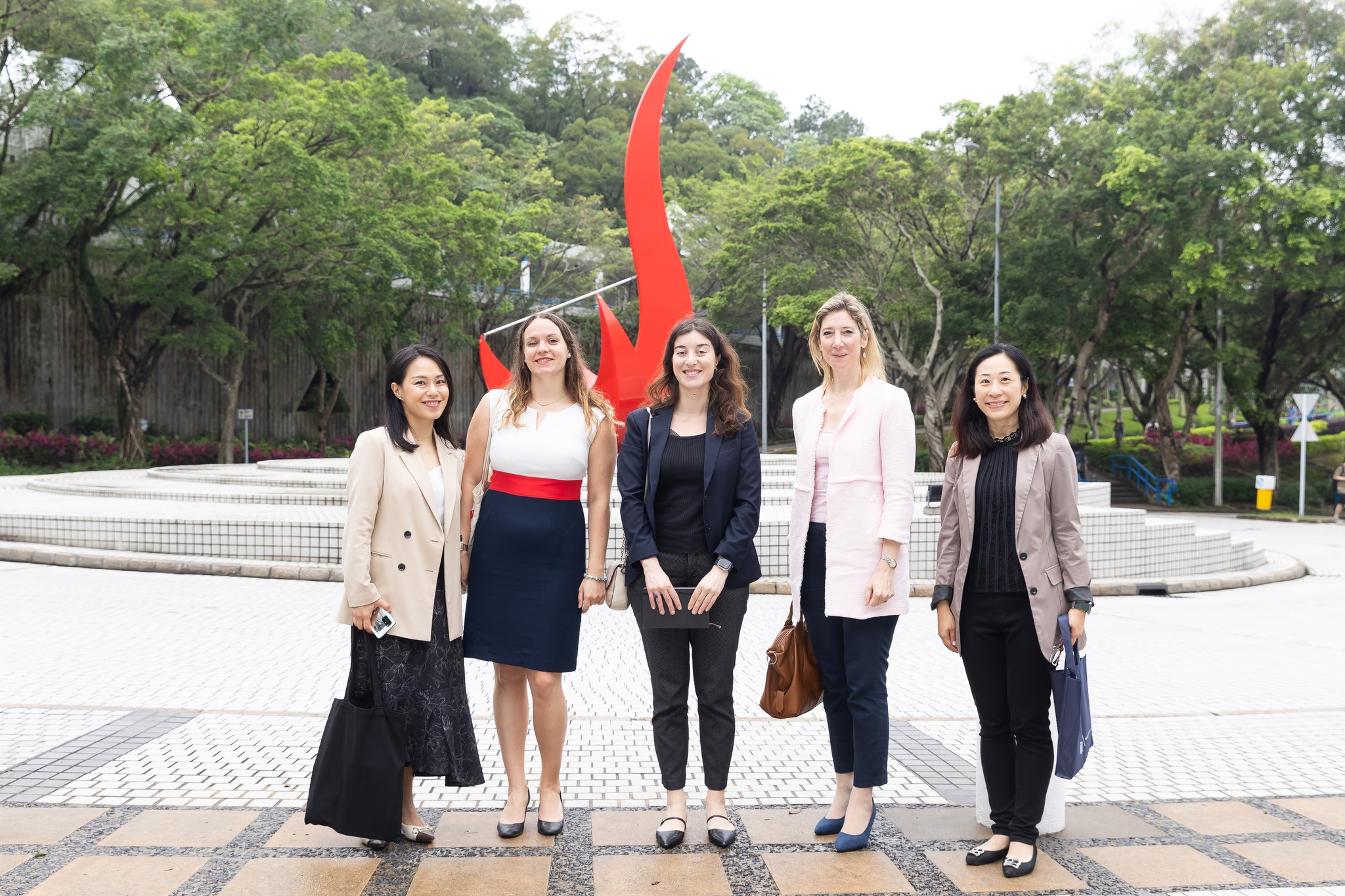 CG Drulhe and her delegation takes a photo in front of the iconic “Red Bird” sculpture at the Piazza.