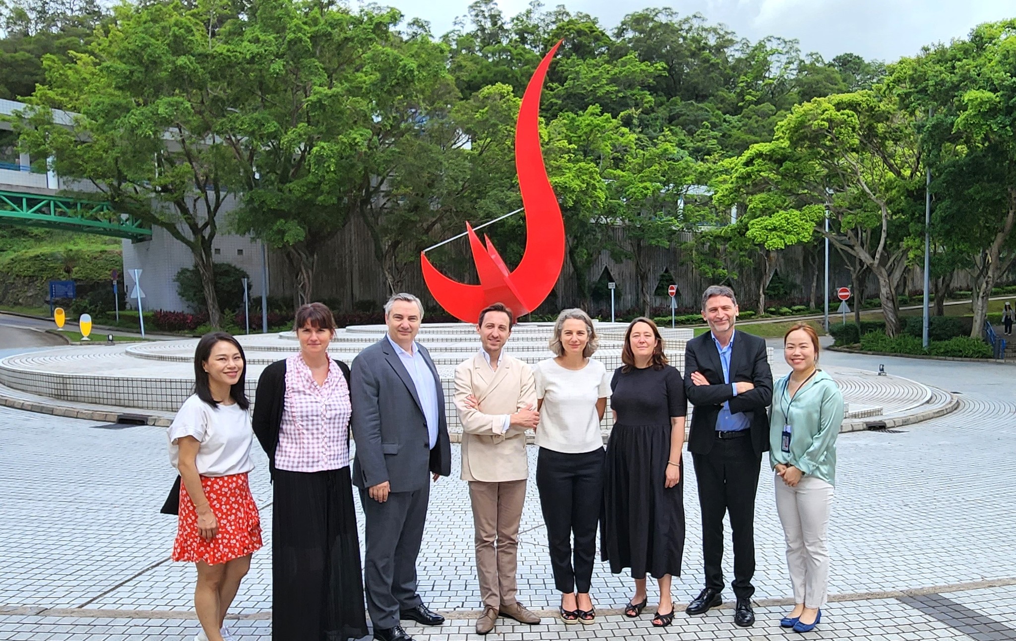 The French delegation takes a photo in front of the iconic “Red Bird” sculpture at the Piazza.