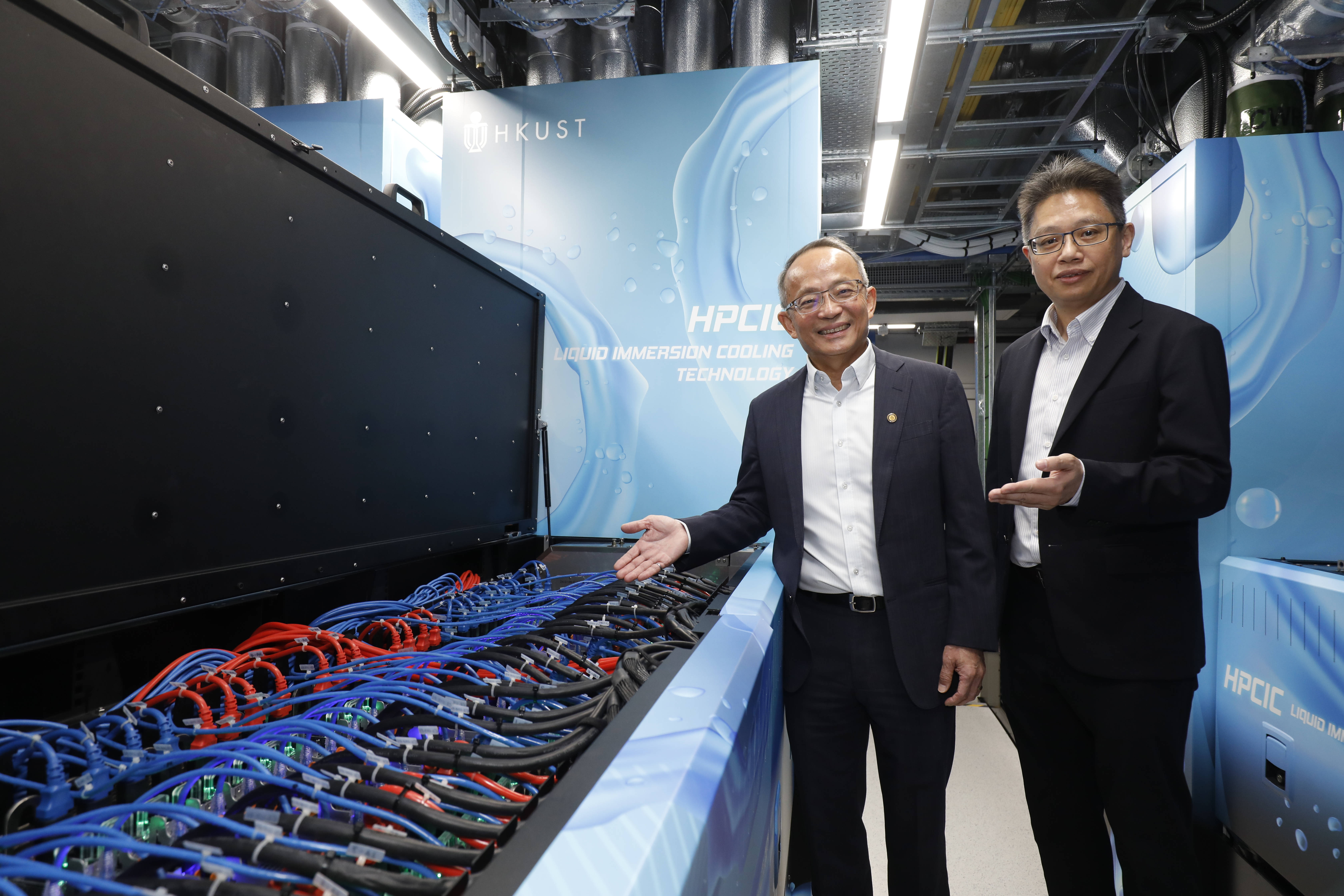 HKUST Vice-President for Research and Development Prof. Tim CHENG (left) and Director of HKUST’s Information Technology Services Center Dr. Samuel KWAN introduce the city’s largest Liquid Immersion Cooling system launched by the University.