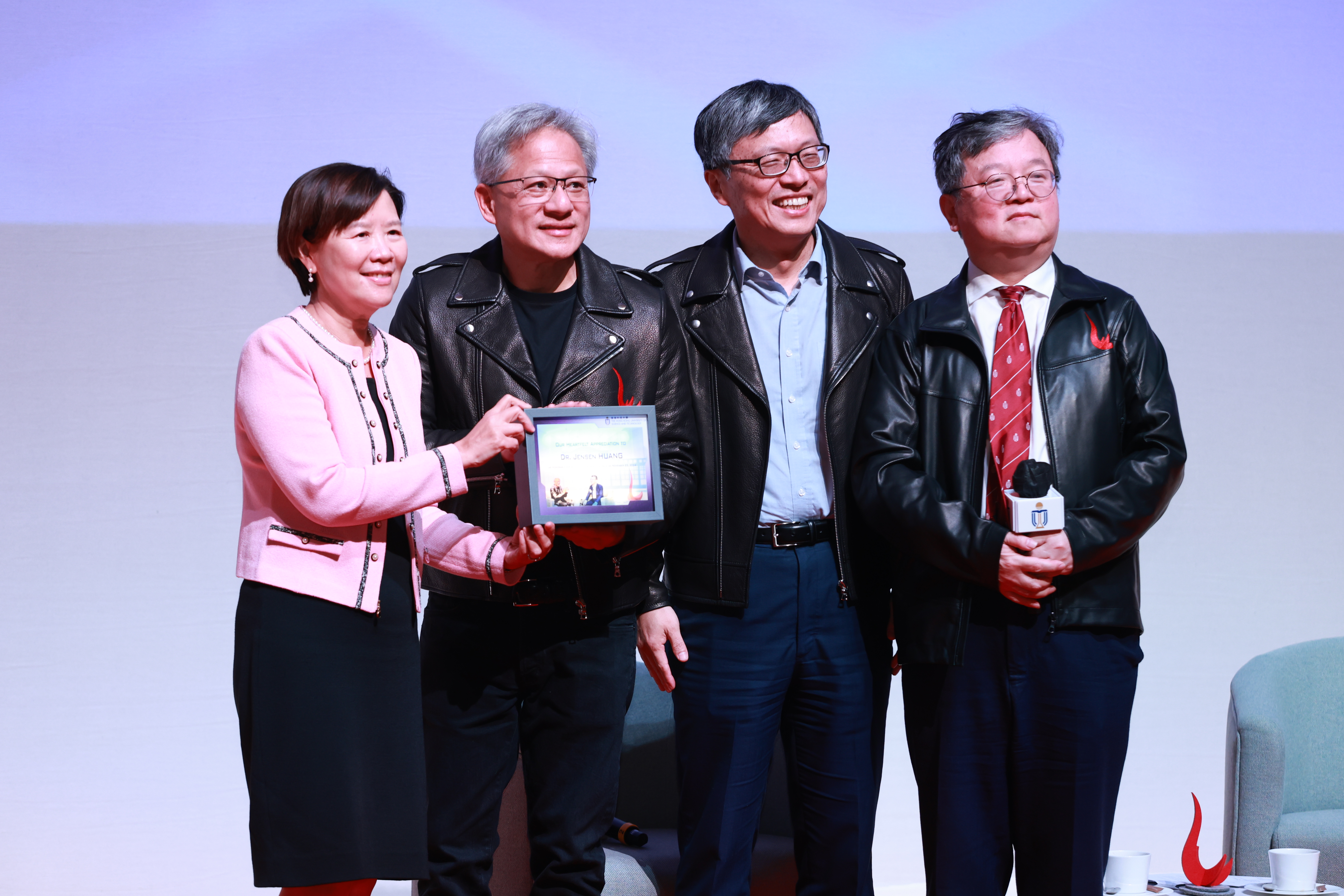 HKUST President Prof. Nancy Ip (left), along with Council Chairman Prof. Harry SHUM (second right) and Provost Prof. GUO Yike (right), presented a gift to Dr. Jensen Huang as a token of appreciation. 