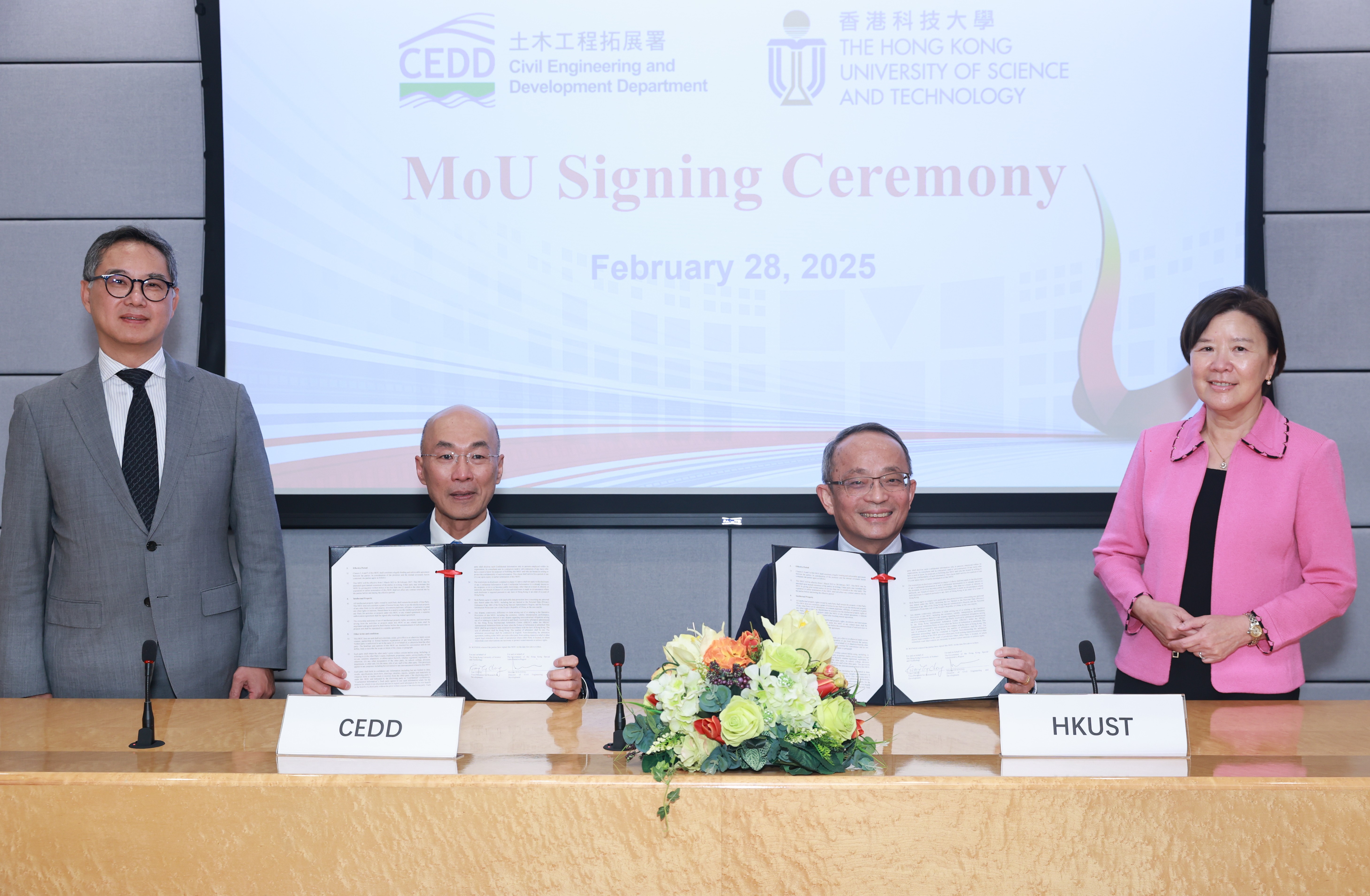 The Hong Kong University of Science and Technology (HKUST) and The Civil Engineering and Development Department (CEDD) sign a Memorandum of Understanding (MoU) on research studies related to sustainable infrastructure development and land formation. Photo shows the Vice-President for Research and Development of HKUST, Professor Tim CHENG (second right), and the Director of Civil Engineering and Development, Mr. Michael FONG (second left), signing the MoU as witnessed by the President of HKUST, Professor Nan