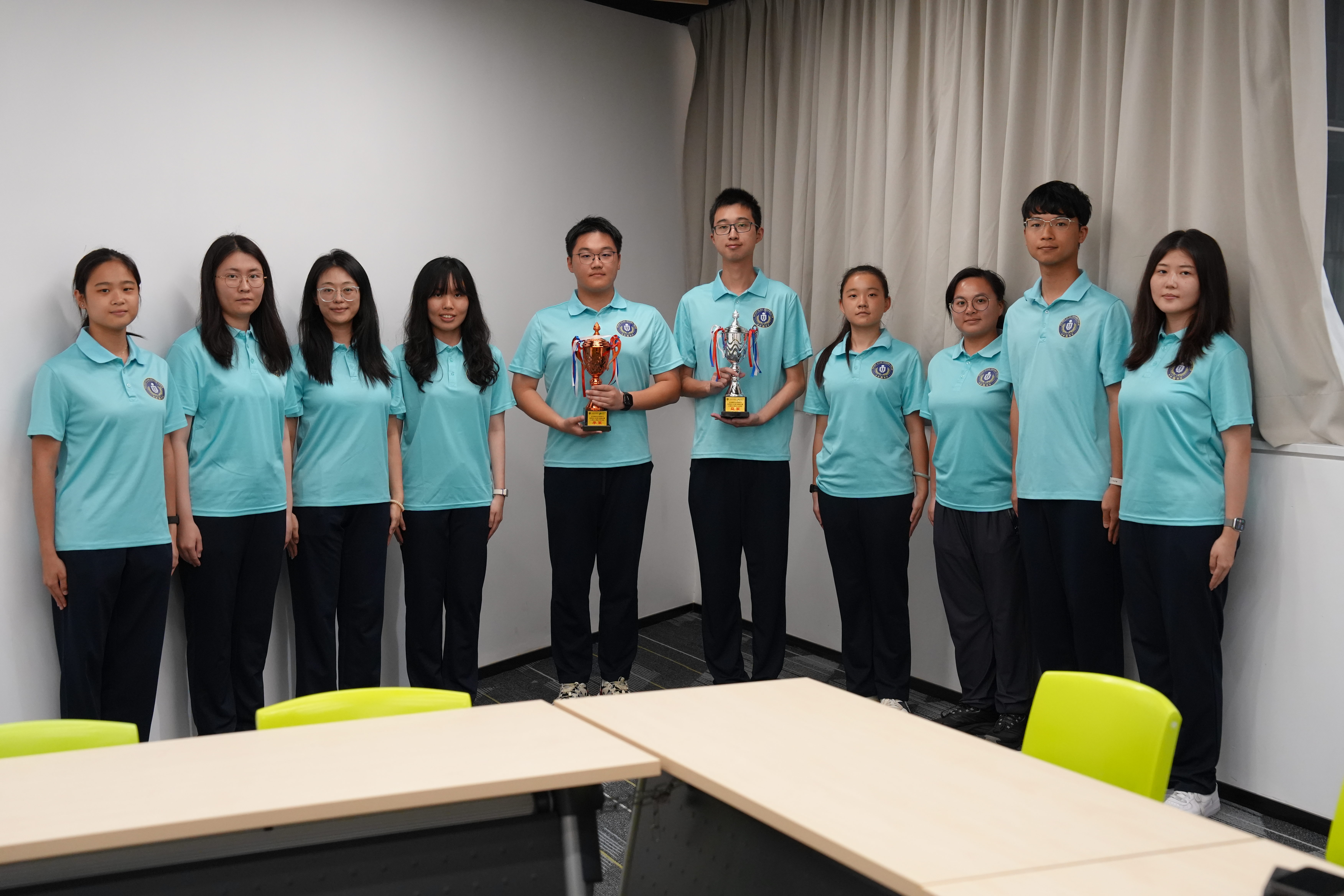 The HKUST flag-raising team proudly displays the Silver and Bronze trophies, the result of teamwork, devotion, and determination.