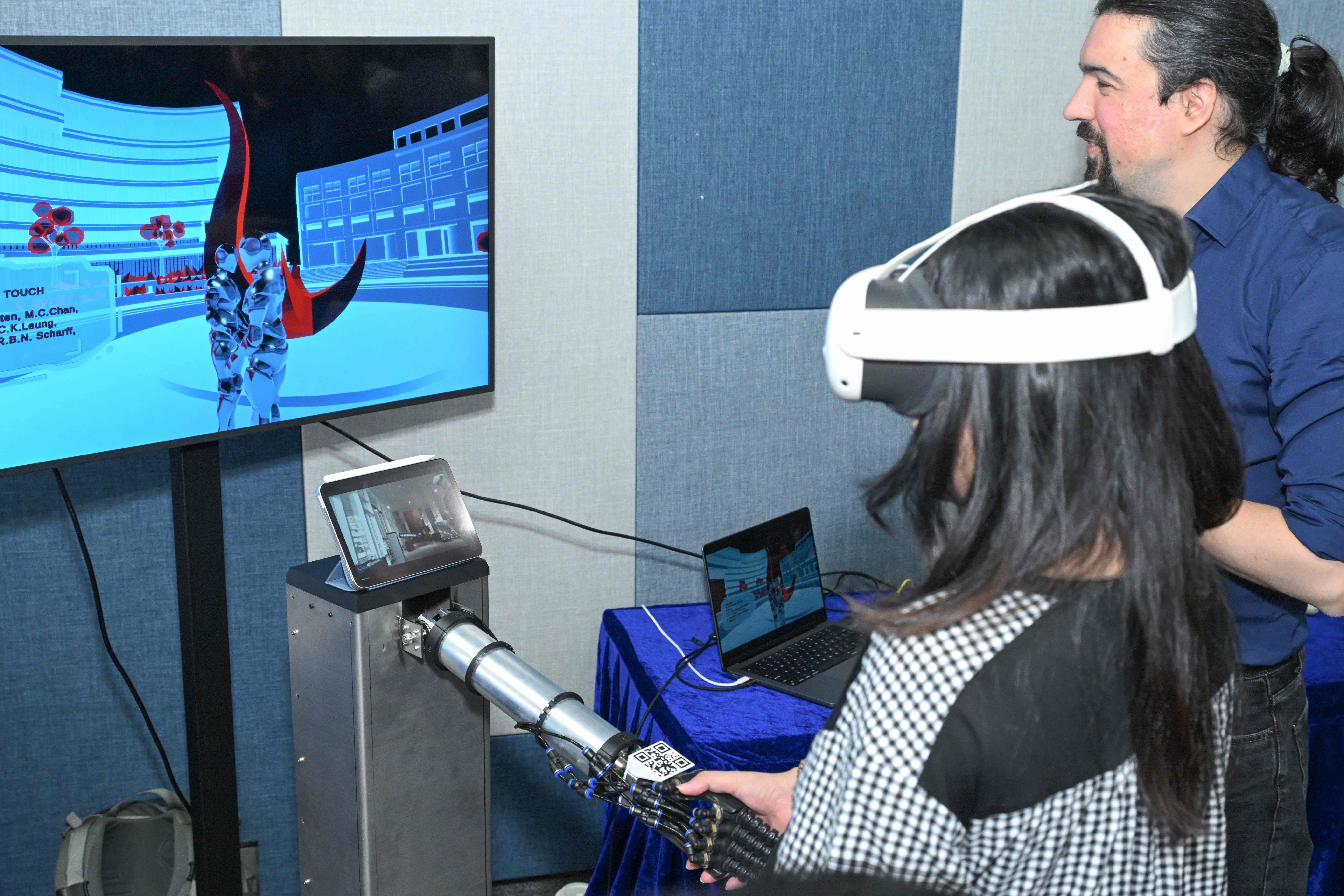 This soft-robot-mediated installation by the HKUST XRIM Lab enables a handshake between the Clear Water Bay and Guangzhou campuses, integrating sensing and tactile replication to create a shared touch experience across distance.
