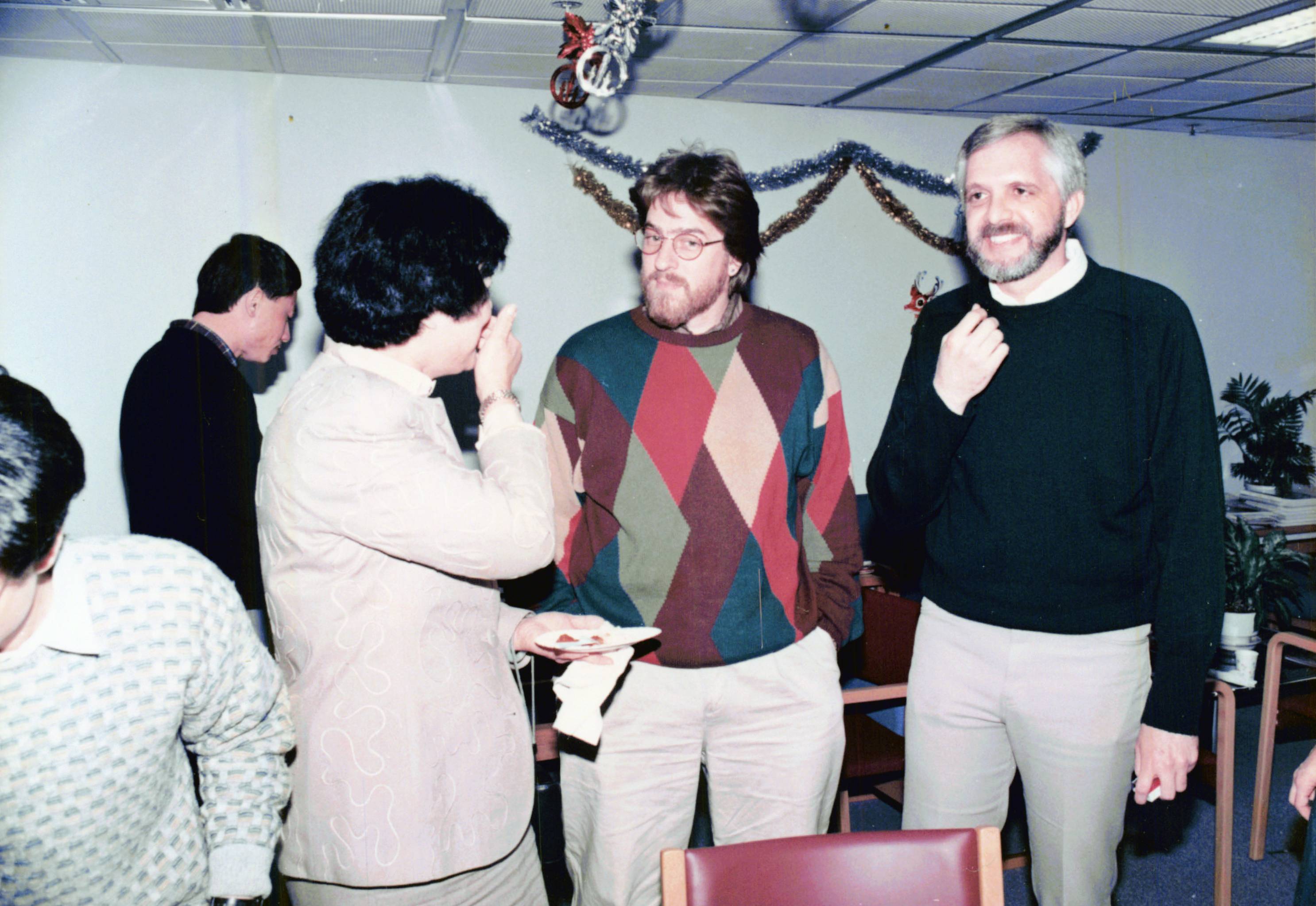 Mr. Spodick (middle) with library staff at a Christmas Party in the 1990s.