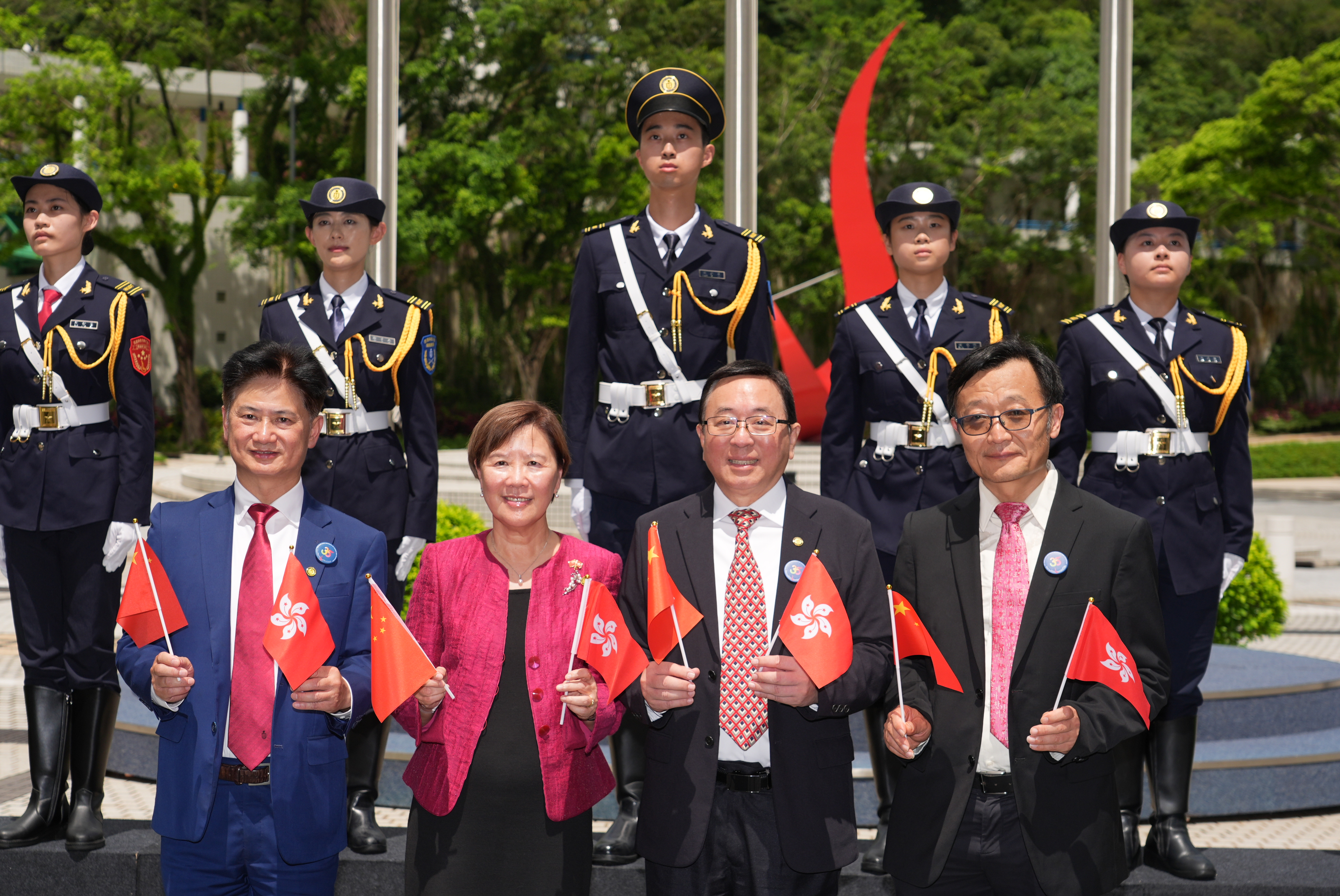 (Front row, from left to right) Prof. Charles Ng, Vice-President for Institutional Advancement; President Nancy Ip at HKUST; Prof. Lionel Ni; and  Prof. Lei Chen, Dean of the Information Hub at HKUST(GZ). Members of the flag-raising team are standing in the background. 