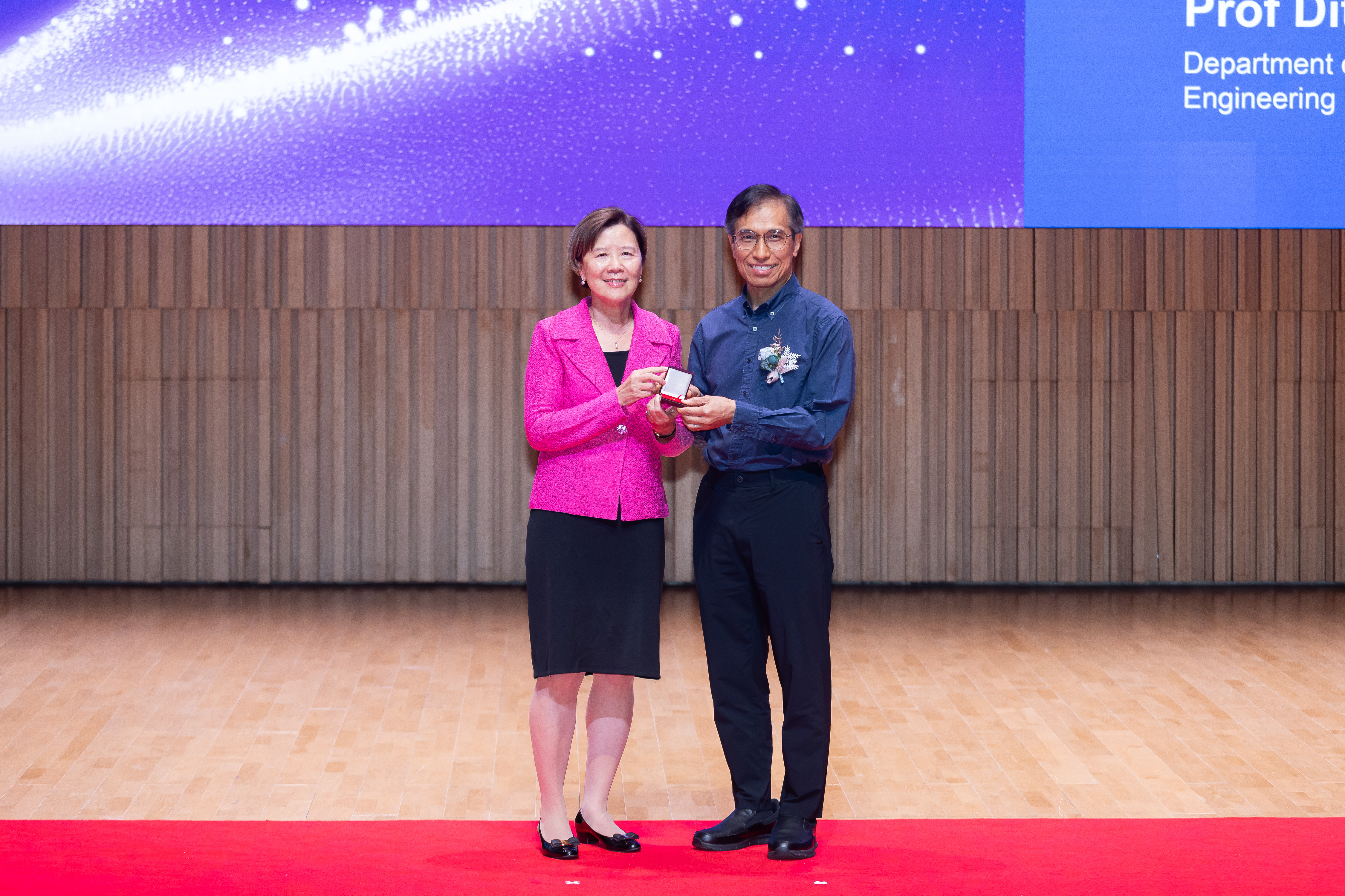 Prof. Yeung (right) became the first HKUST faculty member to receive the 35-Year Long Service Award, accepting this commendation from Prof. Nancy Ip, HKUST President, on June 4, 2026.