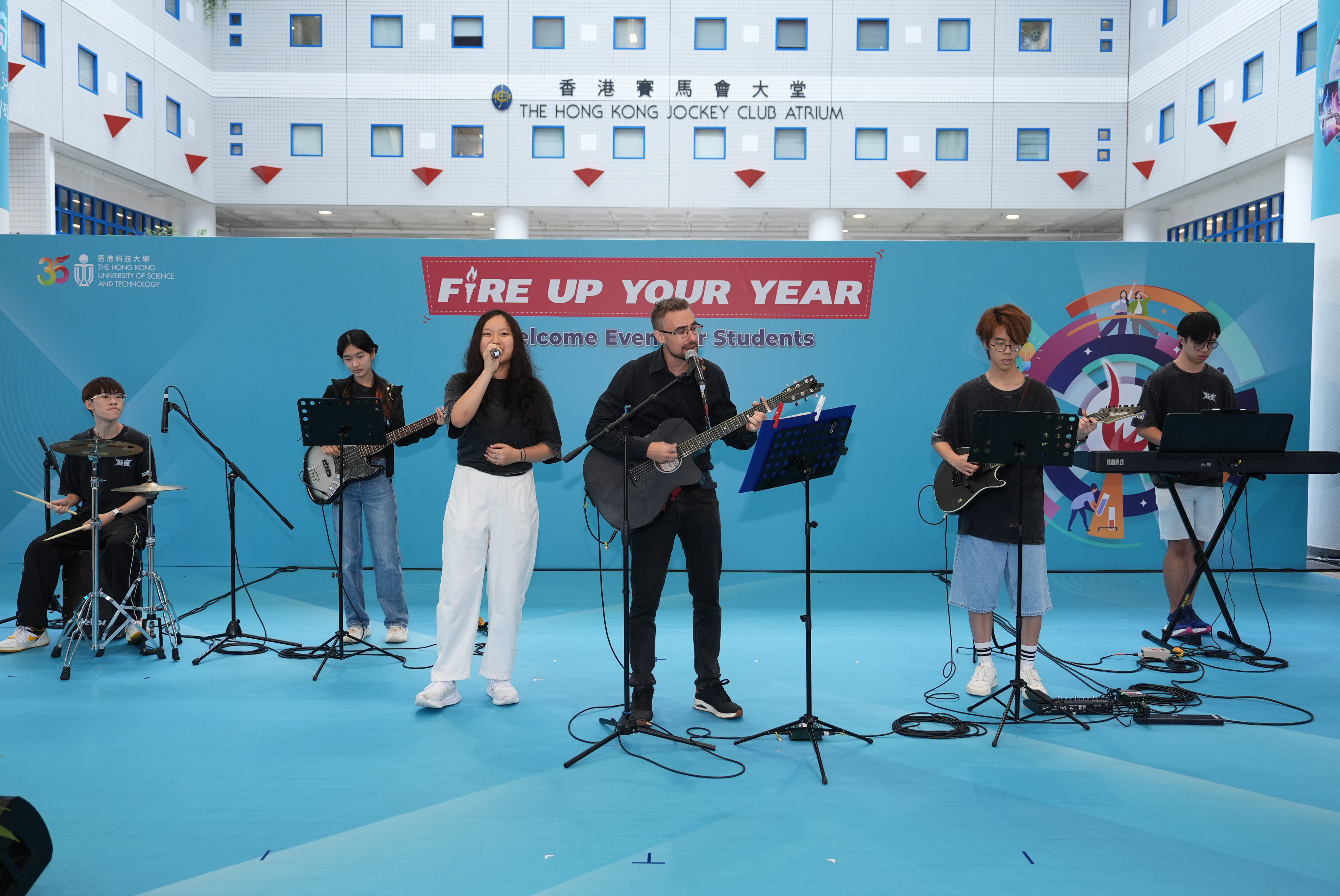 The HKUST Band Society took the stage alongside physics lecturer Dr. Giorgio Manzoni (centre), energizing the Atrium with an electrifying performance that had the crowd clapping, cheering, and singing along.