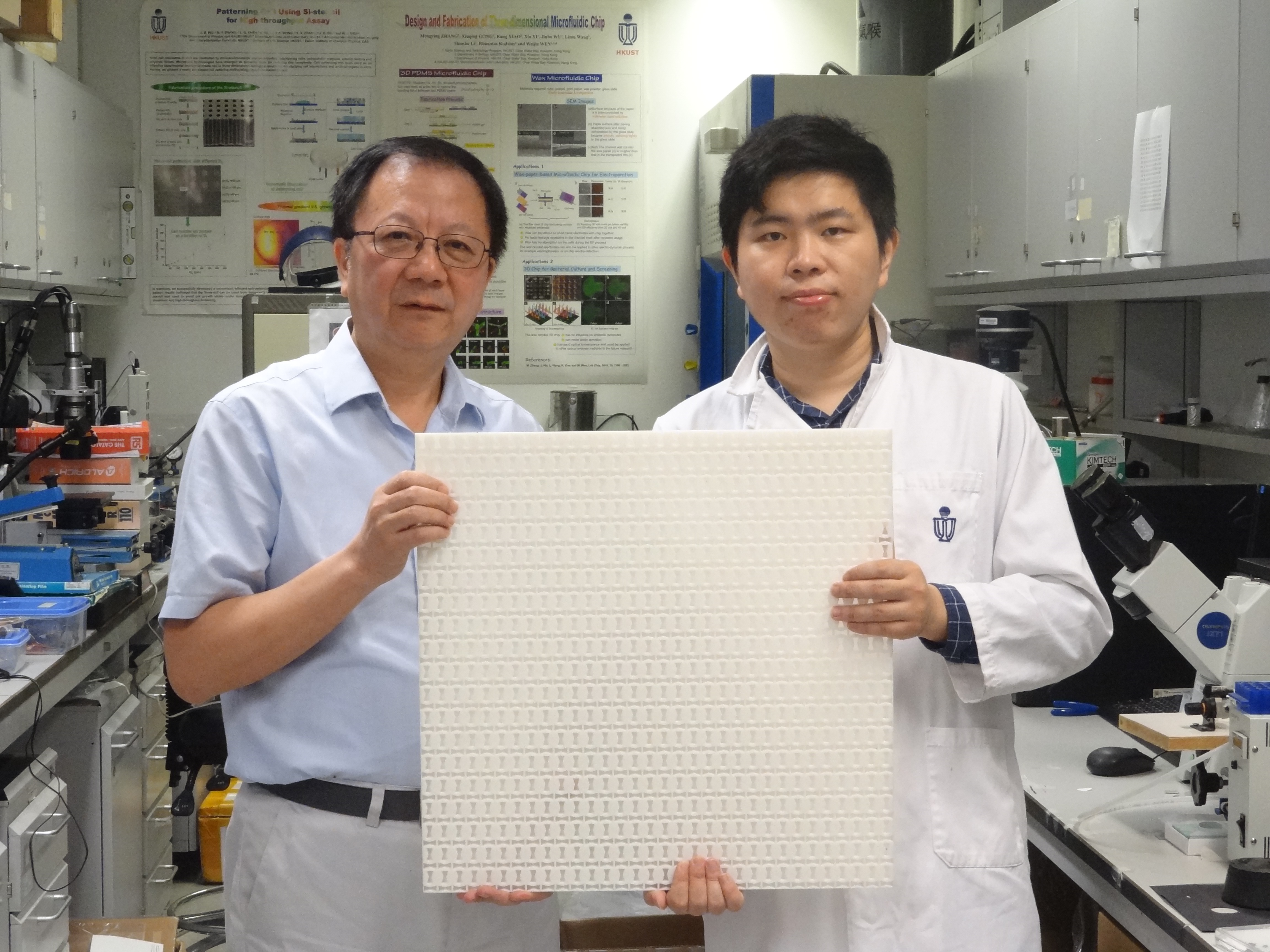 Prof. WEN Weijia (right) and Dr. WU Xiaoxiao demonstrate the experimental samples used to observe "type-II" Dirac cones.