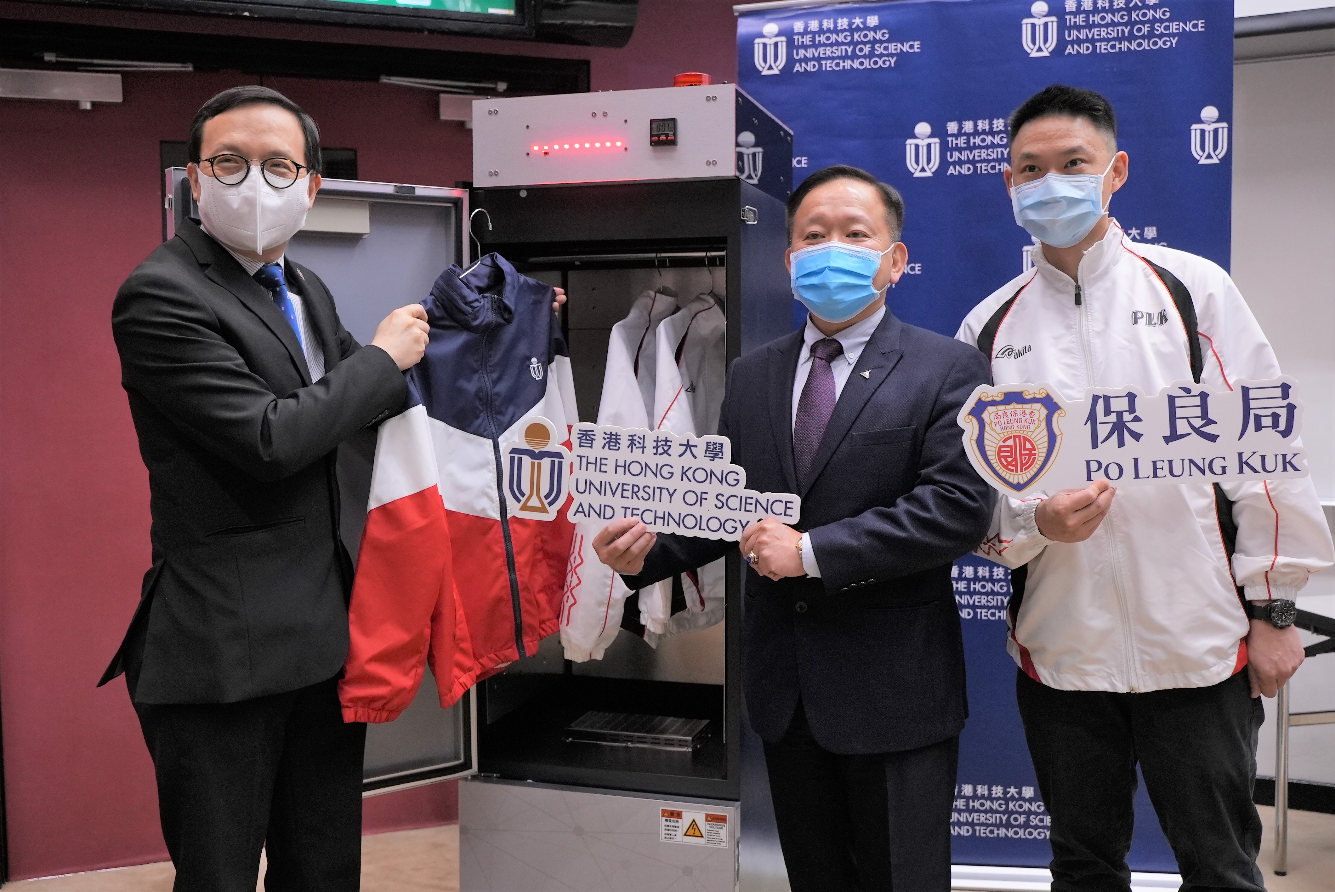 Prof. Ricky LEE Shi-Wei (middle), Chair Professor of the Department of Mechanical and Aerospace Engineering at HKUST demonstrates how the UVC LED disinfection closet works, along with Mr. LAM Kwok Wai (left) and Mr. Martin MAK, Principal and Assistant Warden respectively of the Po Leung Kuk Yu Lee Mo Fan Memorial School.