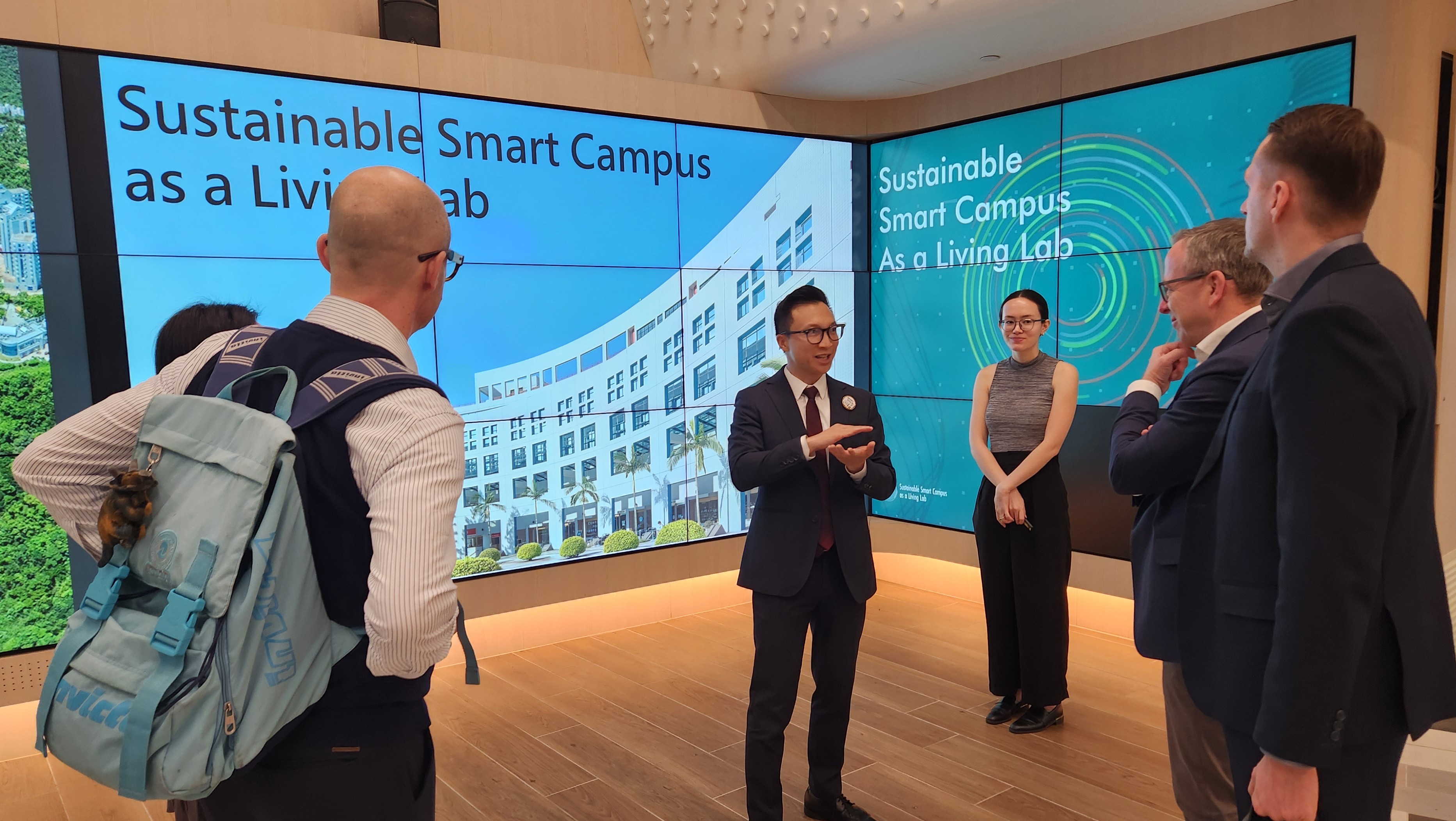 Sustainability/Net-Zero Office Assistant Director (third left) shares the overview of HKUST’s Sustainable Smart Campus as a Living Lab to the delegation.