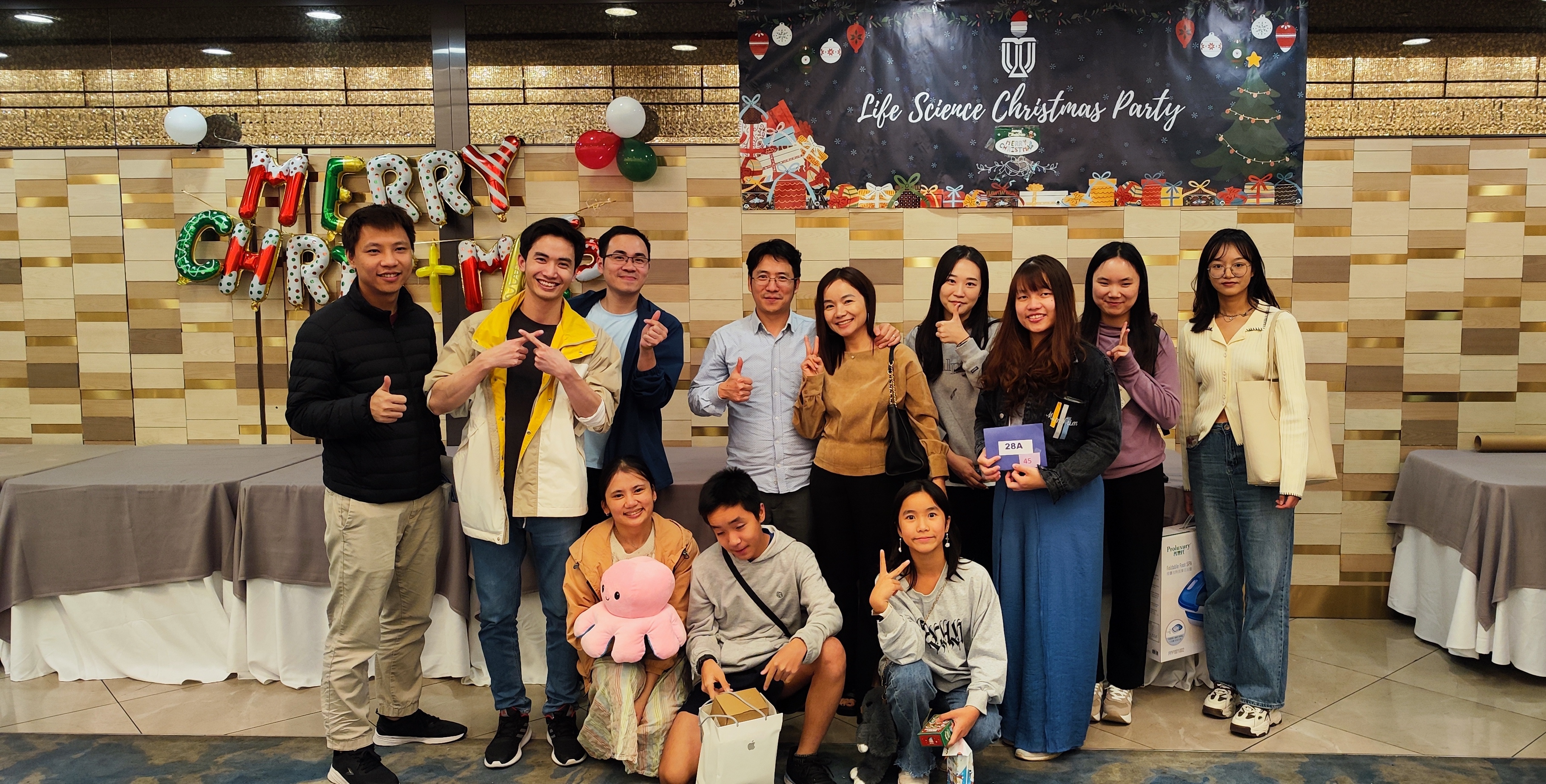 Prof. Nguyen (fourth from left) with his family and members of his lab at a recent Division of Life Science Christmas Party at HKUST, with the first author of the Nature research paper, Minh Khoa NGO (third from left).
