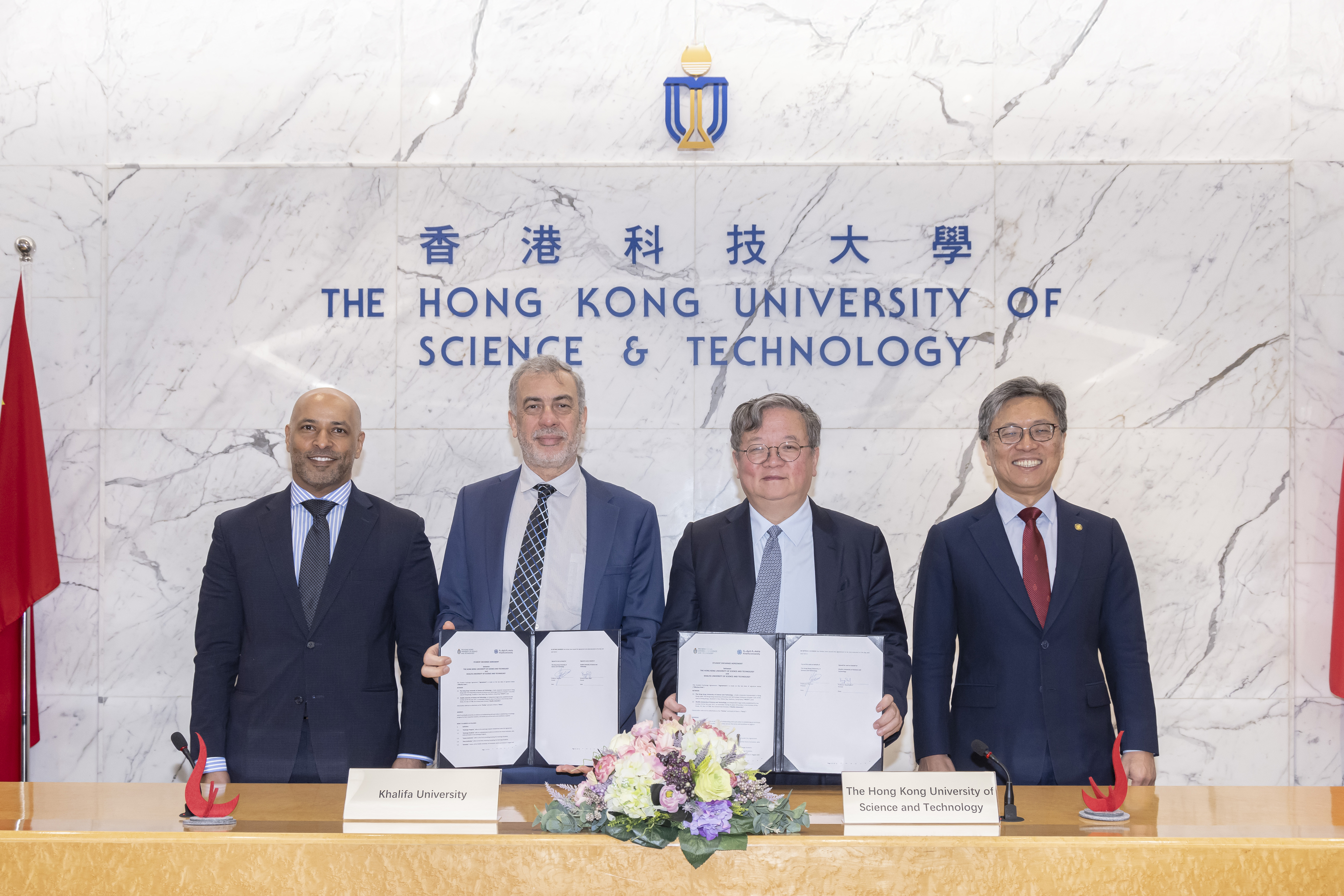 HKUST Provost Prof. Yike GUO (second right) and KU Provost Prof. Bayan SHARIF (second left) sign a university-level student exchange agreement after the meeting, witnessed by Council Chairman Prof. Harry Shum (first right) and President H.E. Prof. Ebrahim Al Hajri (first left).