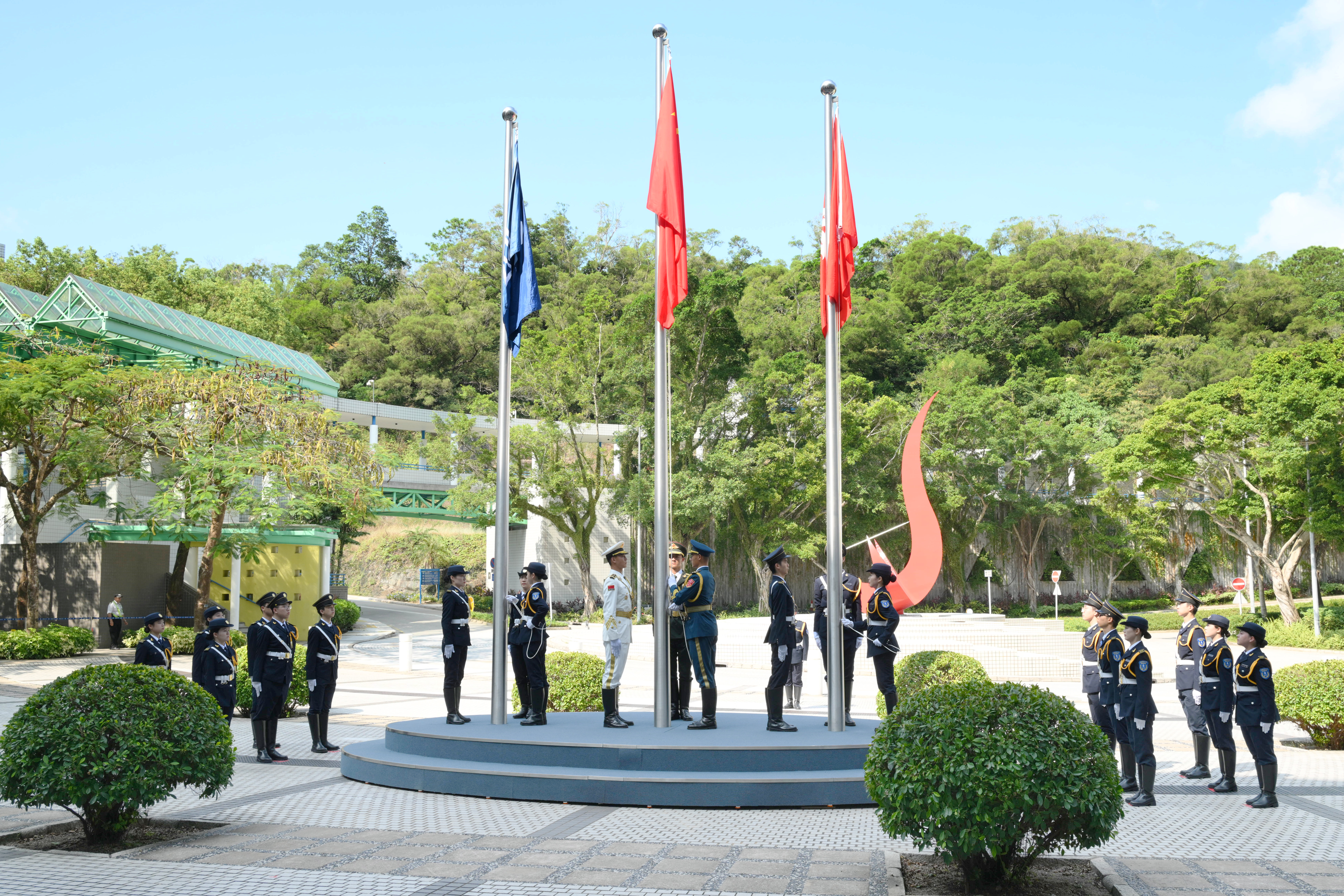 The National Flag of the People's Republic of China, the Flag of the HKSAR, and the HKUST Flag, were solemnly hoisted before the Red Bird Sundial Sculpture at the HKUST campus to celebrate the 77th Anniversary of the Founding of the People's Republic of China.