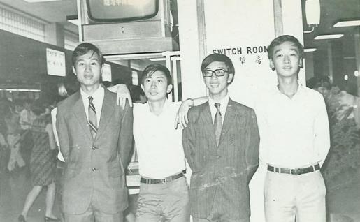  Prof Chan (bespectacled) and Prof Hoi-Sing Kwok (now Chair Professor at HKUST), both looking smart in suits at point of departure for the US.