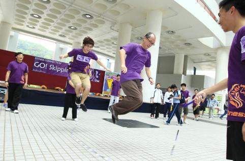  President Chan skips in synchronization with a student.