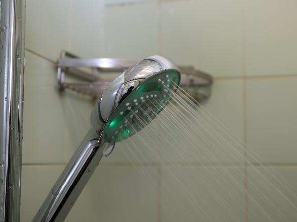 Smart showerhead with green light on.