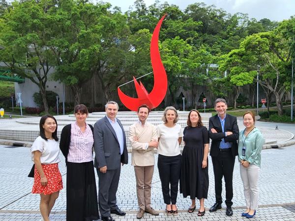 The French delegation takes a photo in front of the iconic “Red Bird” sculpture at the Piazza.