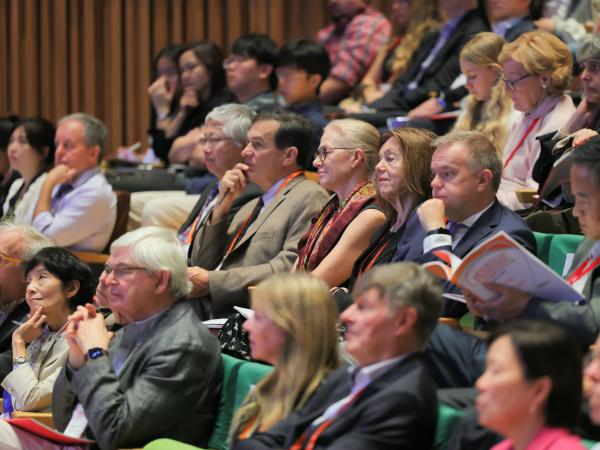 A captivated audience listens to leading scientists at the symposium.