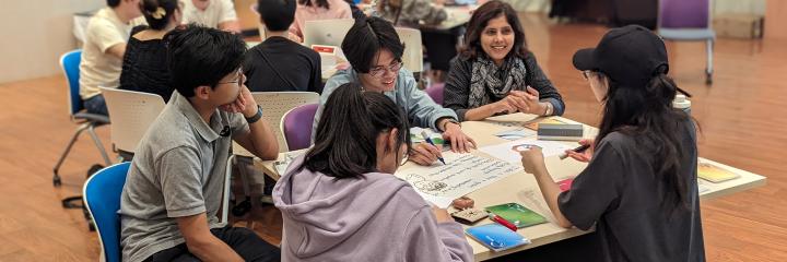 Students around a table, working on an activity