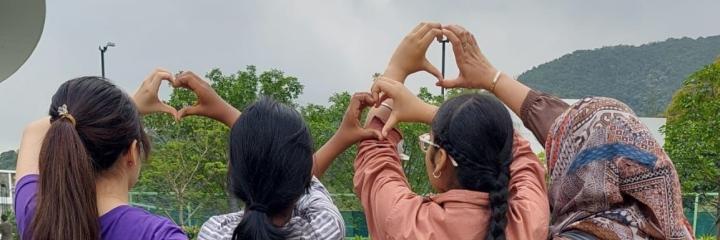 Students making heart signs together