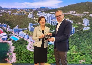 President Prof. Nancy IP (left) presents a souvenir to the Managing Director of Dieter Schwarz Foundation Prof. Dr. Gunther FRIEDL (right).