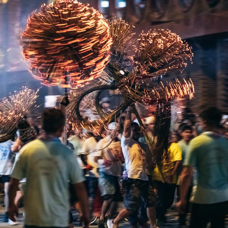 Tai Hang Fire Dragon Dance - People performing the dance by holding the body of the dragon, dragon ball and dance through the street