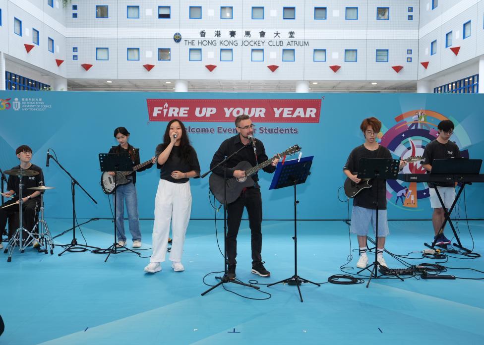 The HKUST Band Society took the stage alongside physics lecturer Dr. Giorgio Manzoni (centre), energizing the Atrium with an electrifying performance that had the crowd clapping, cheering, and singing along.